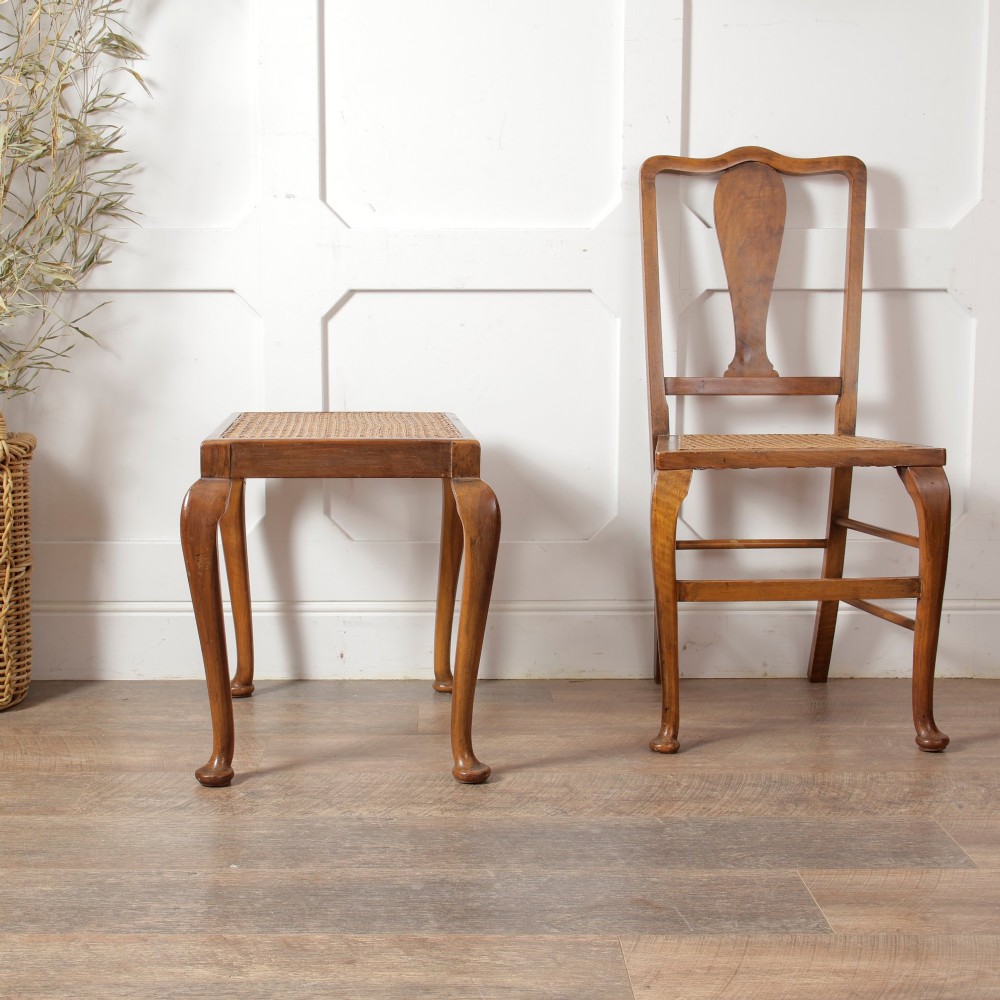 A low walnut luggage stand featuring a rectangular woven rattan top supported by four cabriole legs with pad feet. View X