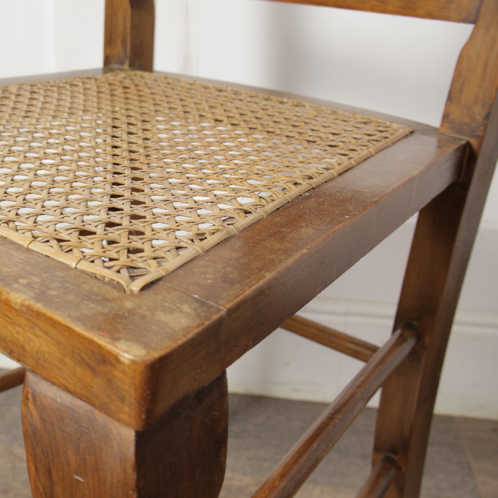 A low walnut luggage stand featuring a rectangular woven rattan top supported by four cabriole legs with pad feet. View XIII