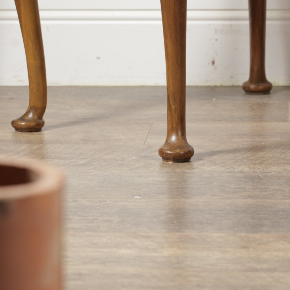 A low walnut luggage stand featuring a rectangular woven rattan top supported by four cabriole legs with pad feet. View XV