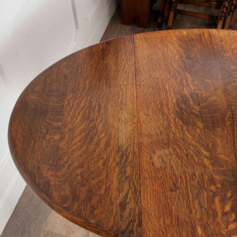 A small oak gateleg side table with turned legs, drop-down side flaps, and a warm brown wood finish. View XIII