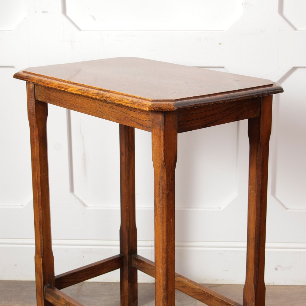 A rectangular warm brown oak side table featuring chamfered legs, bevelled top edges, and lower support stretchers. View IV