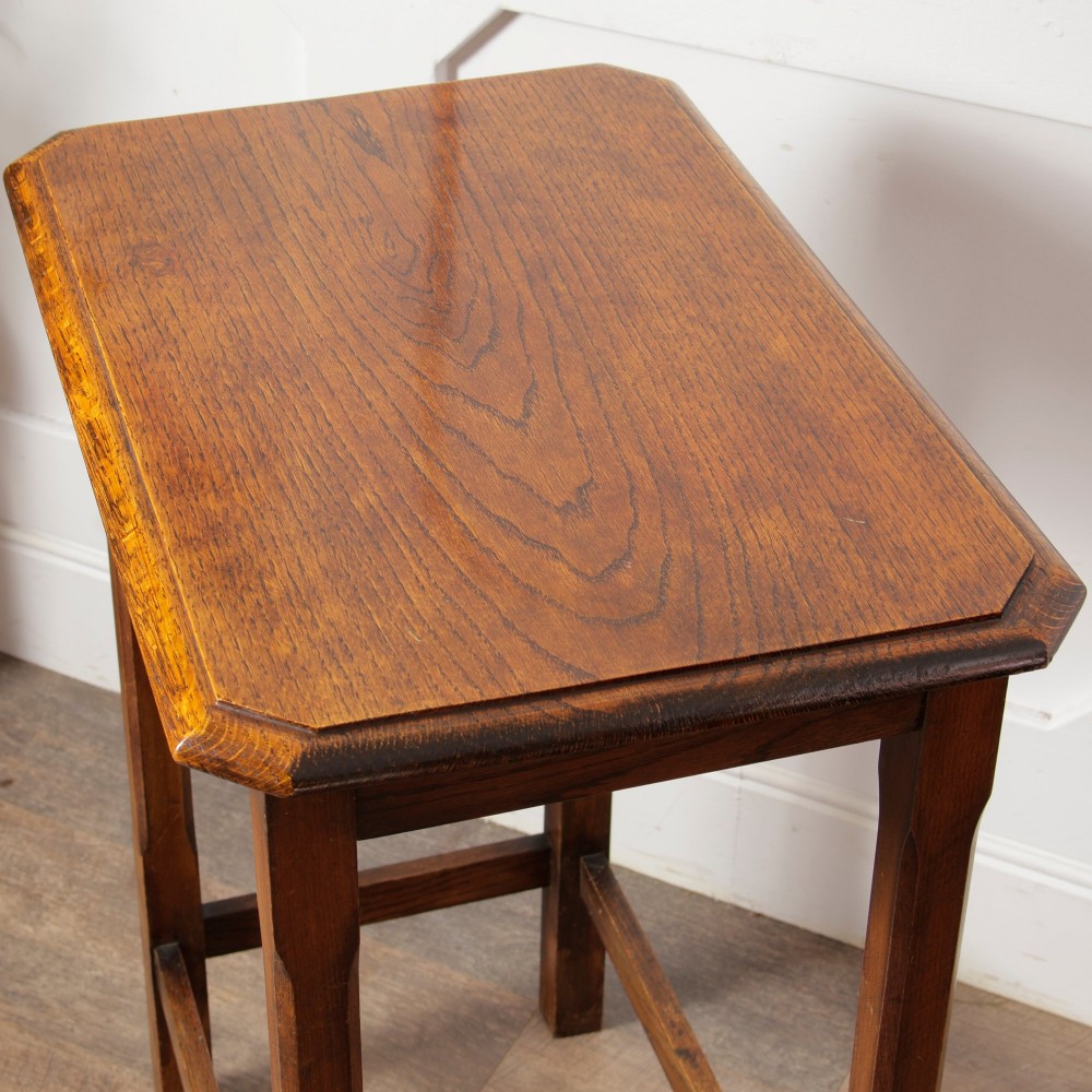 A rectangular warm brown oak side table featuring chamfered legs, bevelled top edges, and lower support stretchers. View V