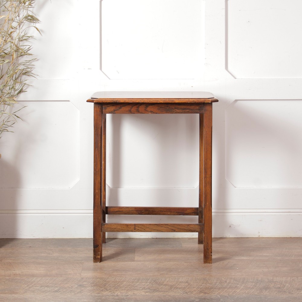 A rectangular warm brown oak side table featuring chamfered legs, bevelled top edges, and lower support stretchers. View VI