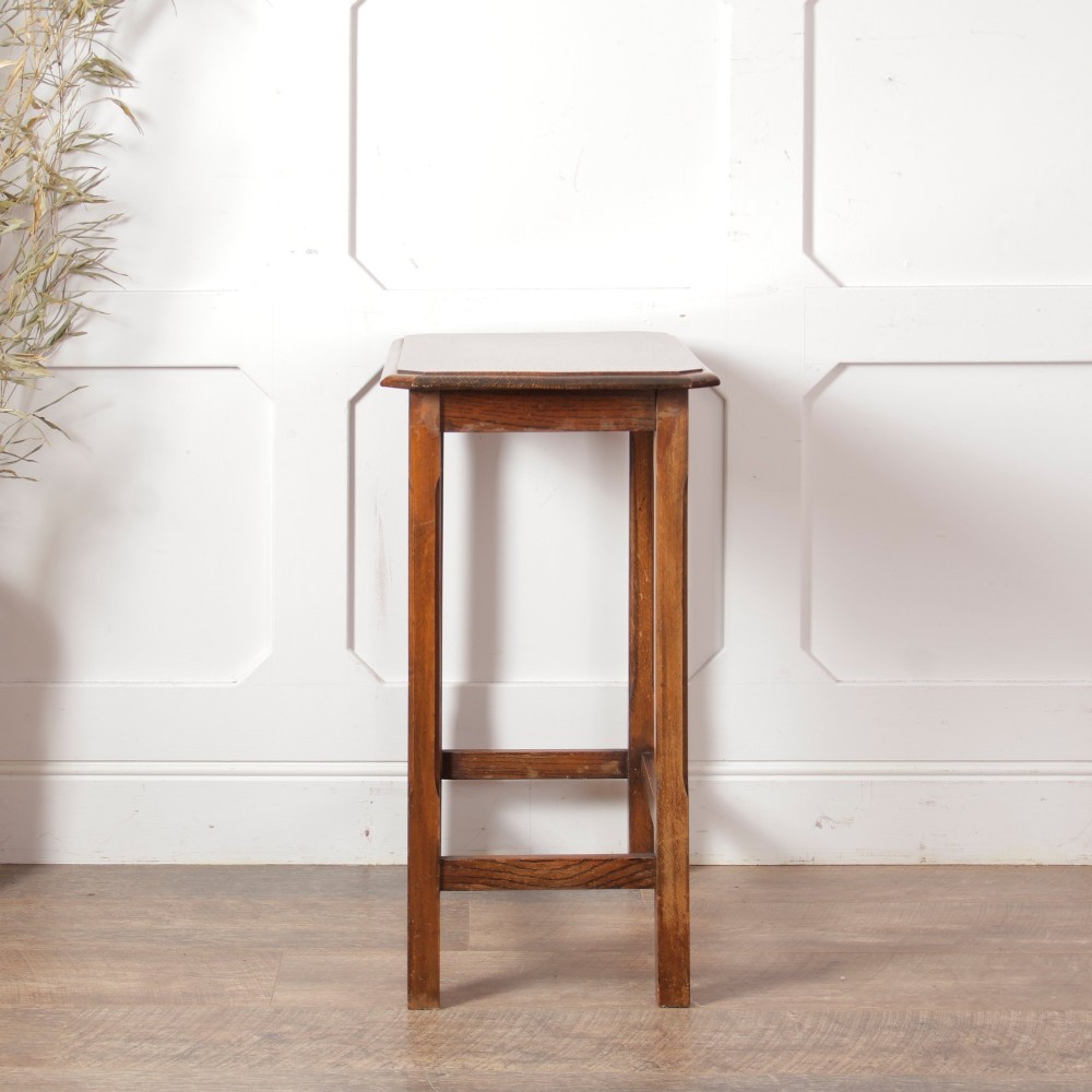 A rectangular warm brown oak side table featuring chamfered legs, bevelled top edges, and lower support stretchers. View VII