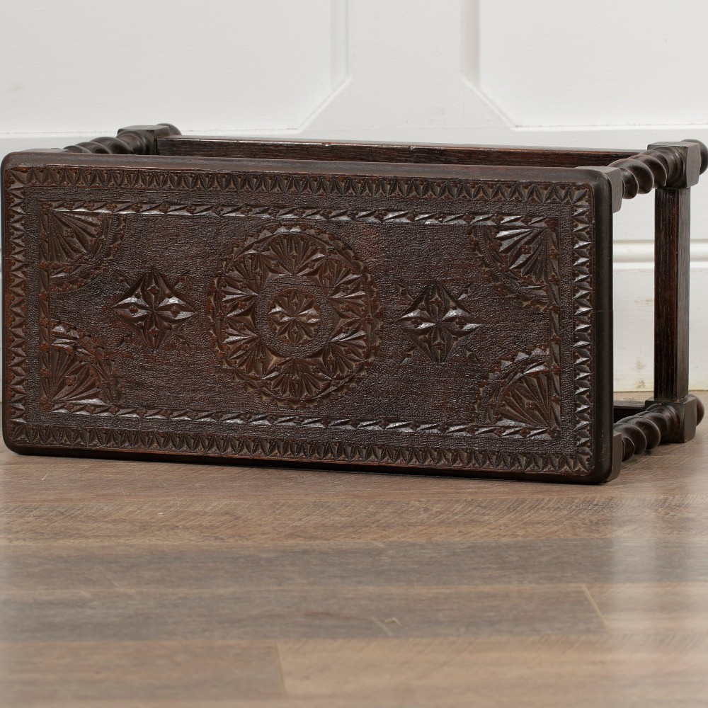 A low dark oak rectangular stool featuring four spiral barley twist legs connected by lower stretchers. View II