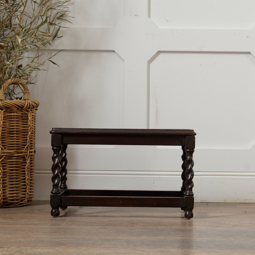 A low dark oak rectangular stool featuring four spiral barley twist legs connected by lower stretchers. View VI