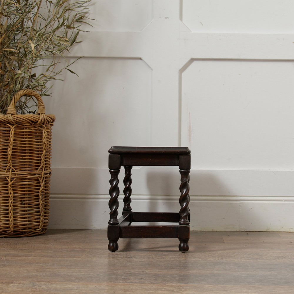 A low dark oak rectangular stool featuring four spiral barley twist legs connected by lower stretchers. View VII