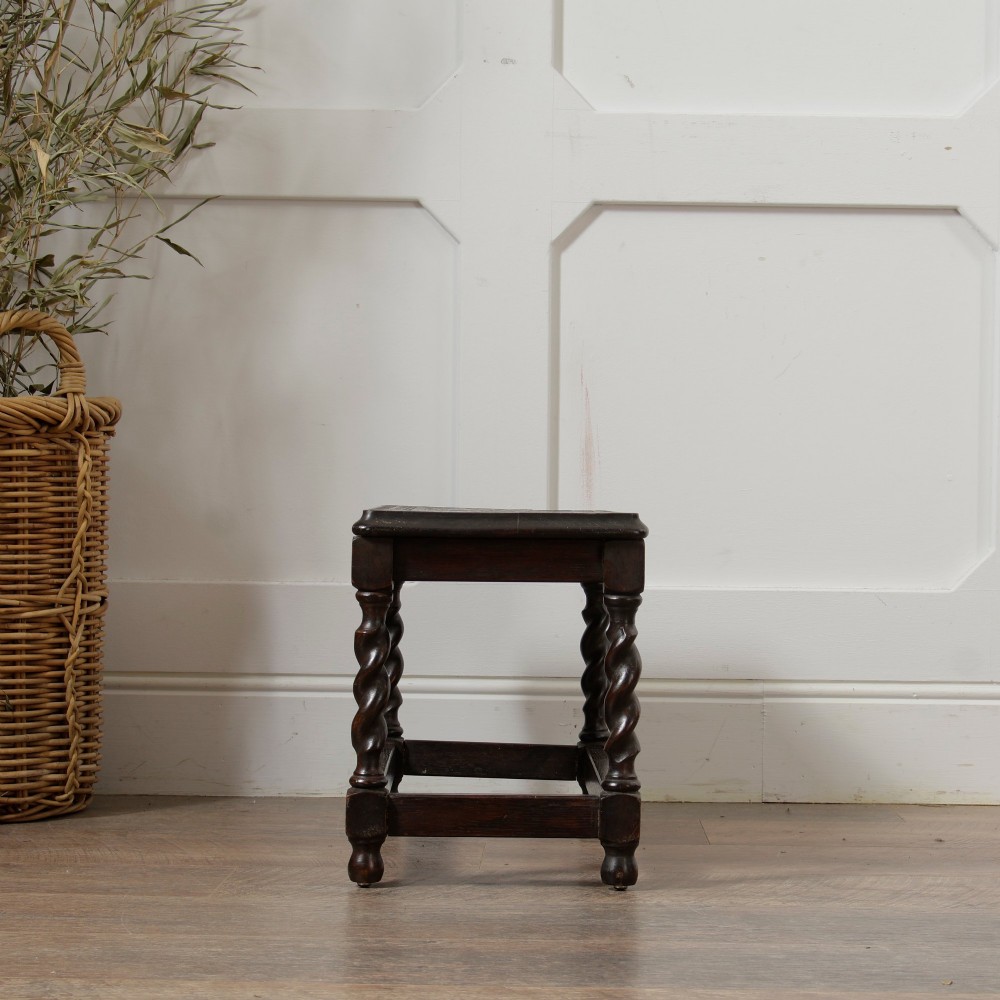 A low dark oak rectangular stool featuring four spiral barley twist legs connected by lower stretchers. View IX