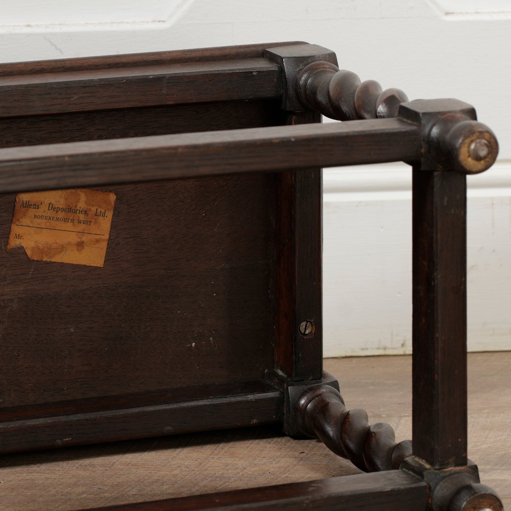 A low dark oak rectangular stool featuring four spiral barley twist legs connected by lower stretchers. View X