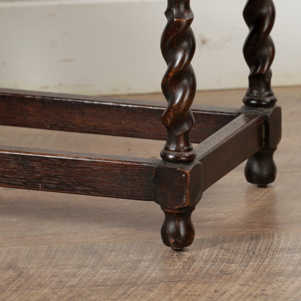 A low dark oak rectangular stool featuring four spiral barley twist legs connected by lower stretchers. View XI