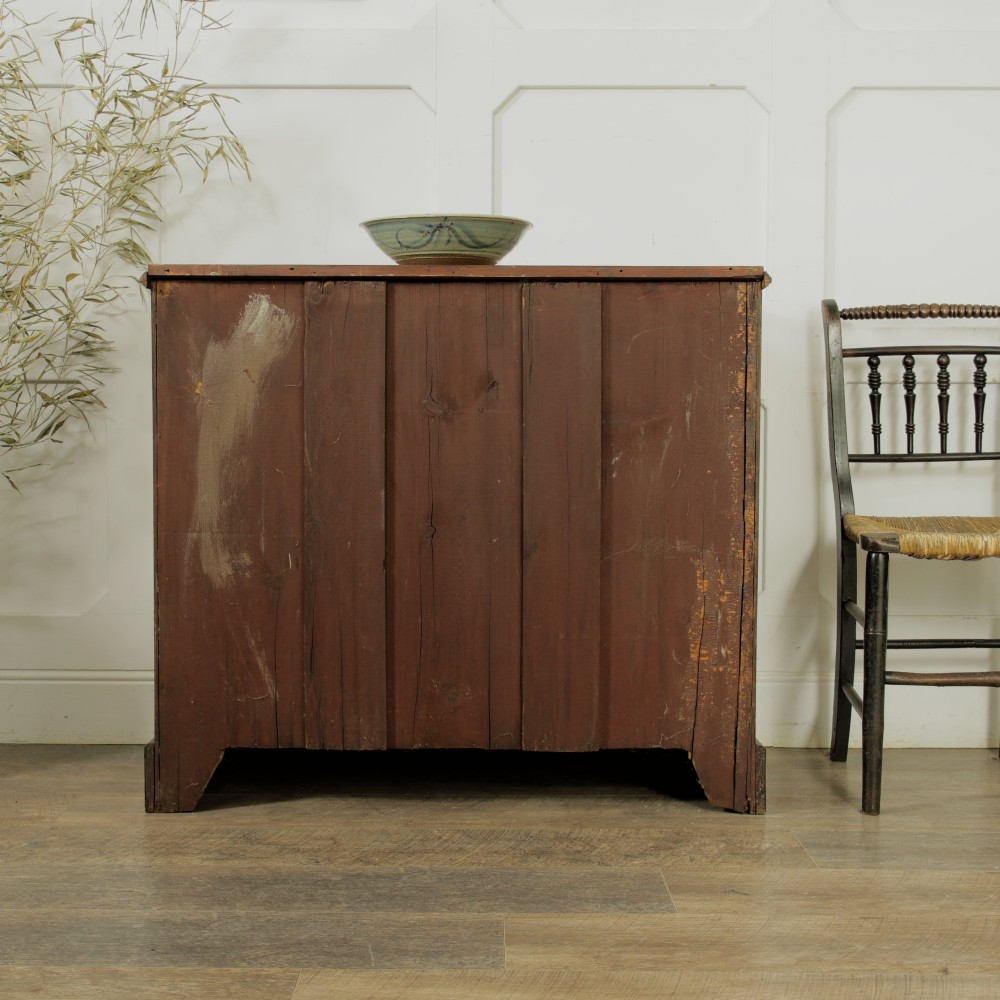 A late Victorian mahogany chest of drawers featuring two short drawers over two long drawers with brass handles on a plinth base. View VII