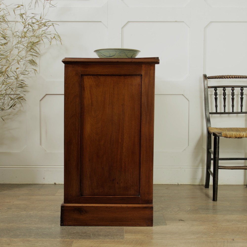 A late Victorian mahogany chest of drawers featuring two short drawers over two long drawers with brass handles on a plinth base. View VIII