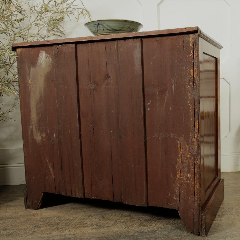 A late Victorian mahogany chest of drawers featuring two short drawers over two long drawers with brass handles on a plinth base. View XI