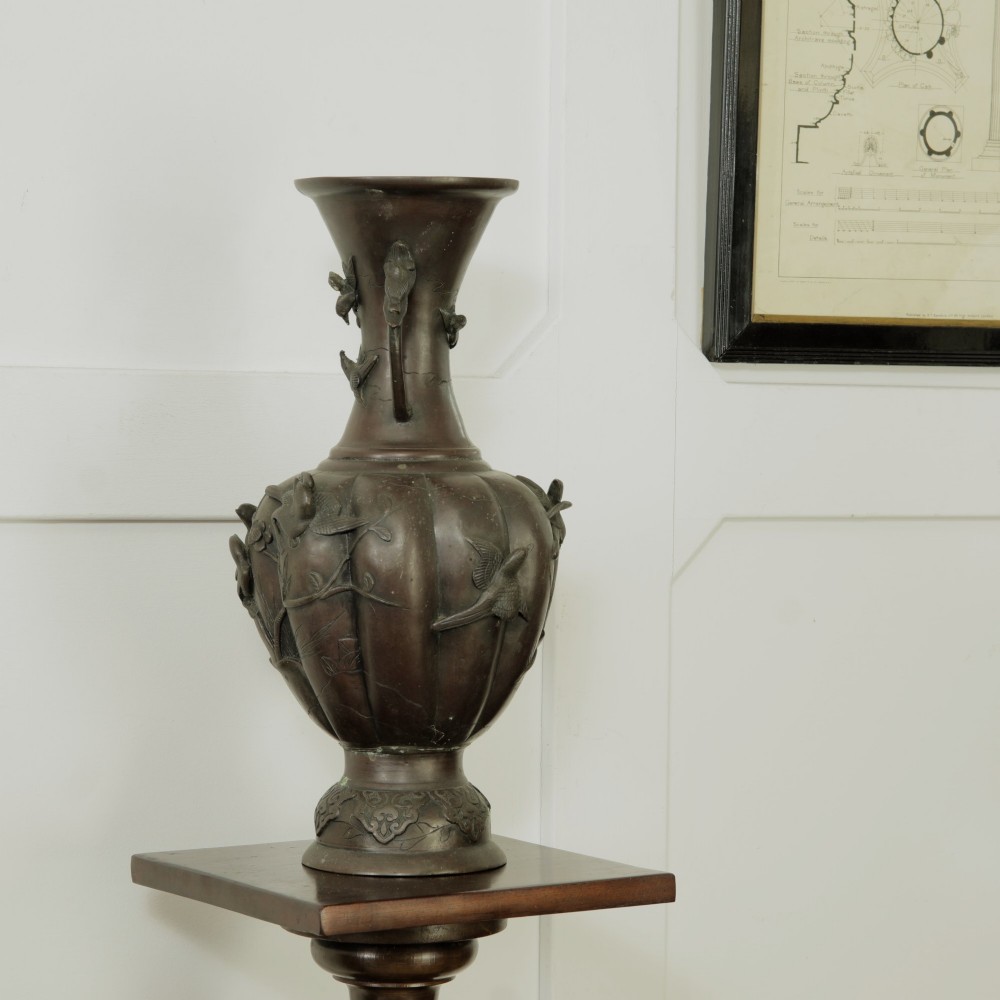 A dark brown patinated bronze vase featuring relief-carved bird motifs, flared neck, and twin dragon handles. View II