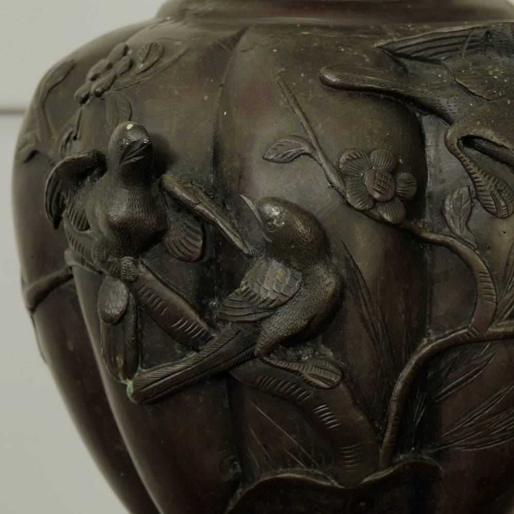 A dark brown patinated bronze vase featuring relief-carved bird motifs, flared neck, and twin dragon handles. View V