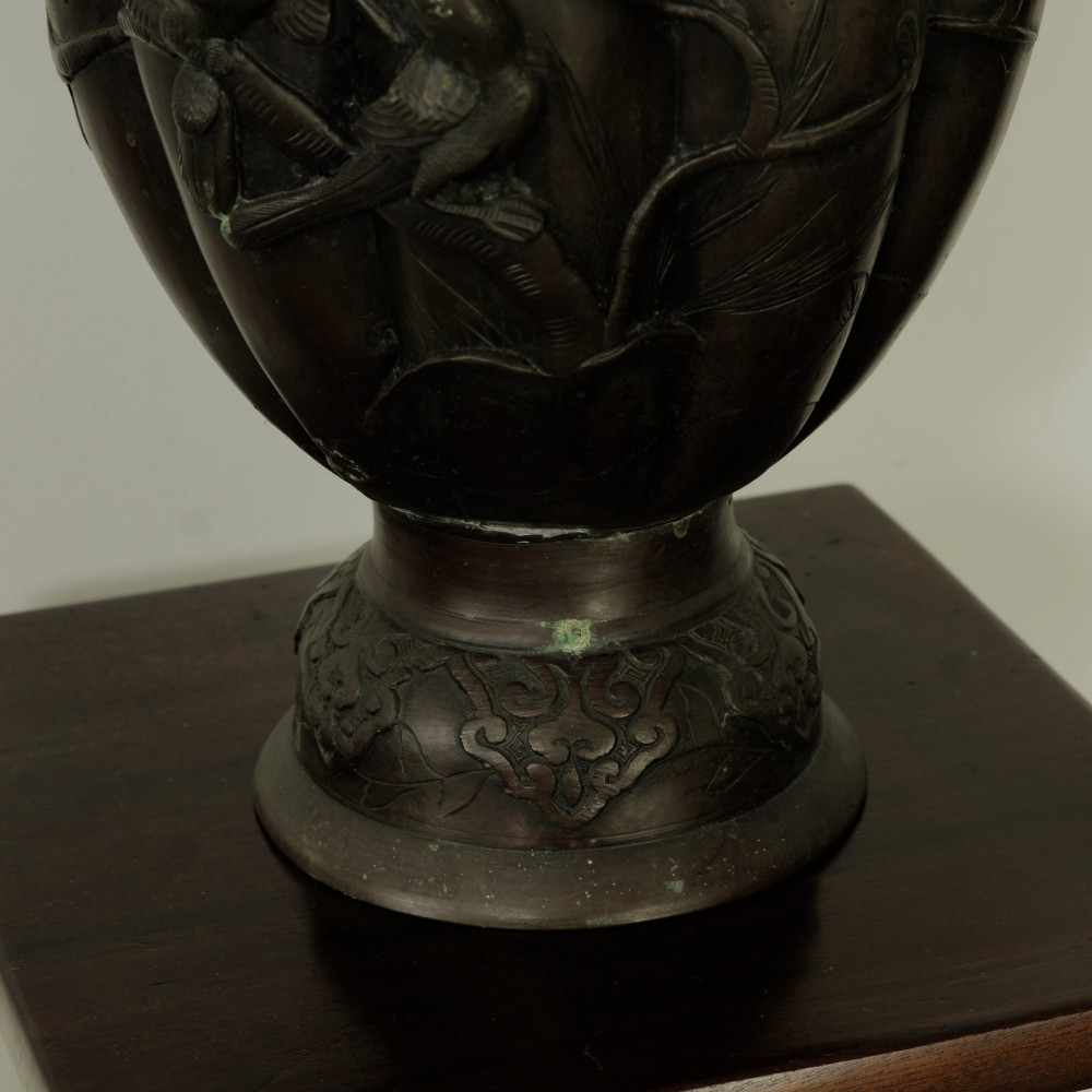 A dark brown patinated bronze vase featuring relief-carved bird motifs, flared neck, and twin dragon handles. View IX