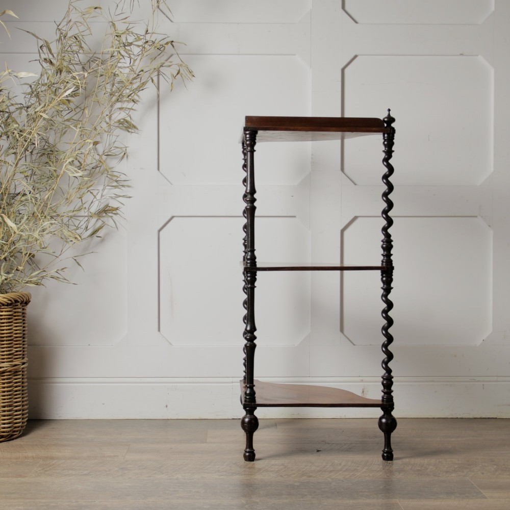 A Victorian mahogany corner whatnot featuring three shaped tiers supported by carved barley twist columns and turned finials. View VII
