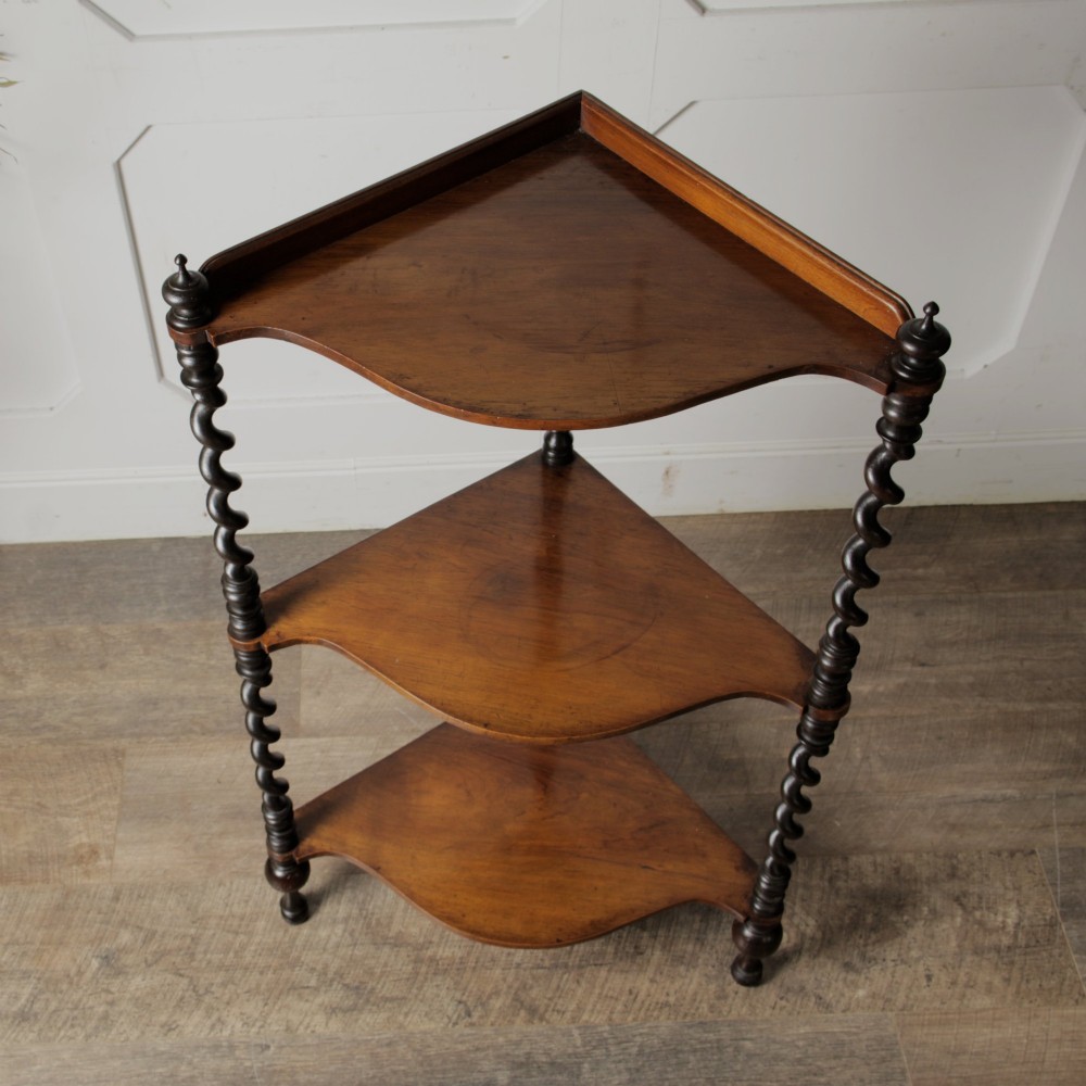 A Victorian mahogany corner whatnot featuring three shaped tiers supported by carved barley twist columns and turned finials. View VIII