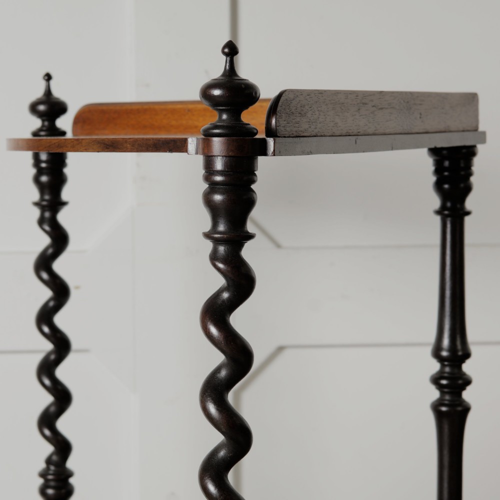 A Victorian mahogany corner whatnot featuring three shaped tiers supported by carved barley twist columns and turned finials. View IX