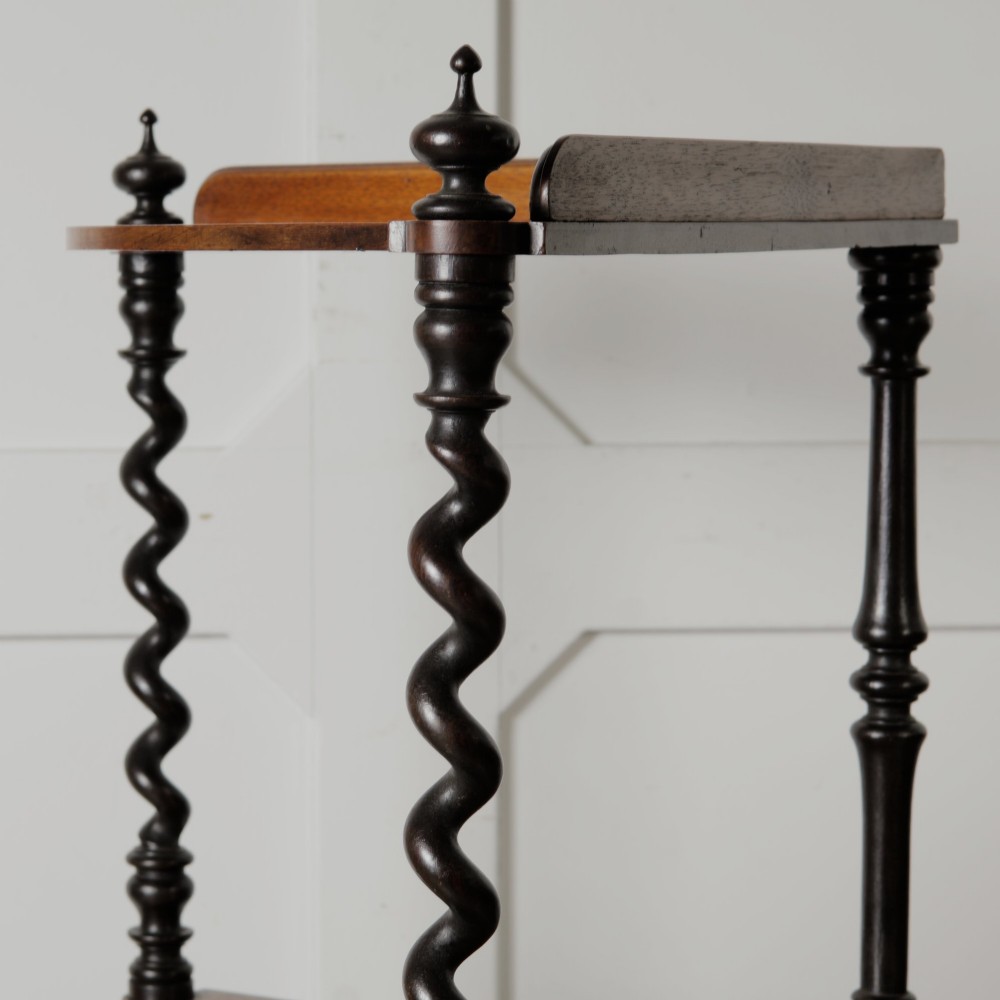 A Victorian mahogany corner whatnot featuring three shaped tiers supported by carved barley twist columns and turned finials. View X