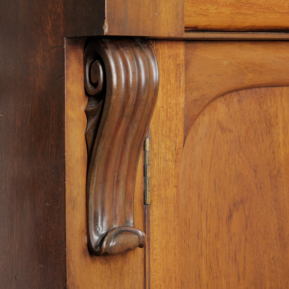 A two-tier Victorian mahogany chiffonier bookcase with arched glass double doors on the upper section and panelled cupboard doors on the lower base. View VIII