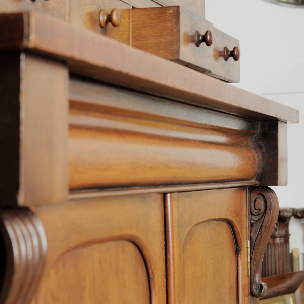 A two-tier Victorian mahogany chiffonier bookcase with arched glass double doors on the upper section and panelled cupboard doors on the lower base. View IX