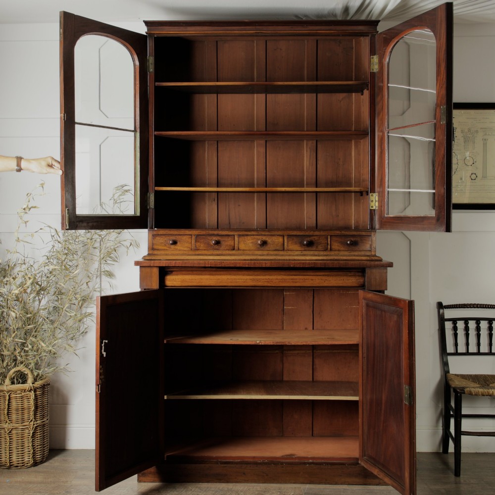 A two-tier Victorian mahogany chiffonier bookcase with arched glass double doors on the upper section and panelled cupboard doors on the lower base. View XII