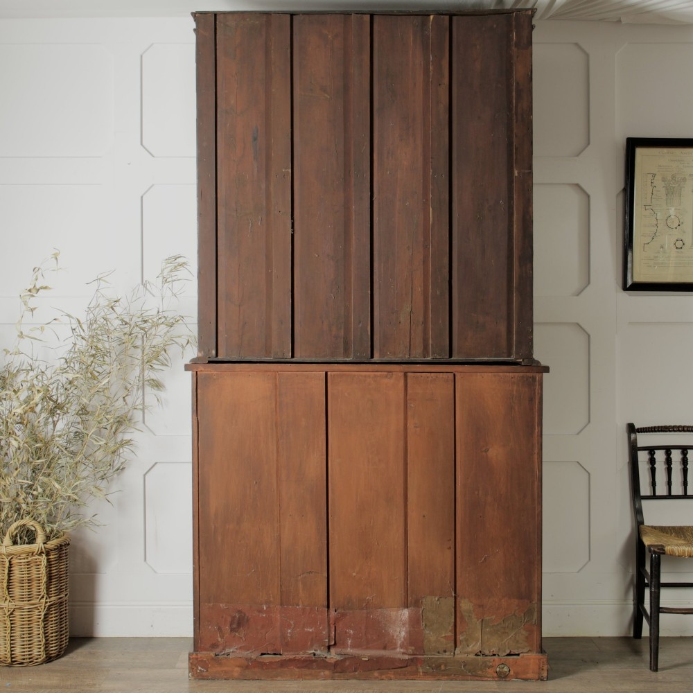 A two-tier Victorian mahogany chiffonier bookcase with arched glass double doors on the upper section and panelled cupboard doors on the lower base. View XIV