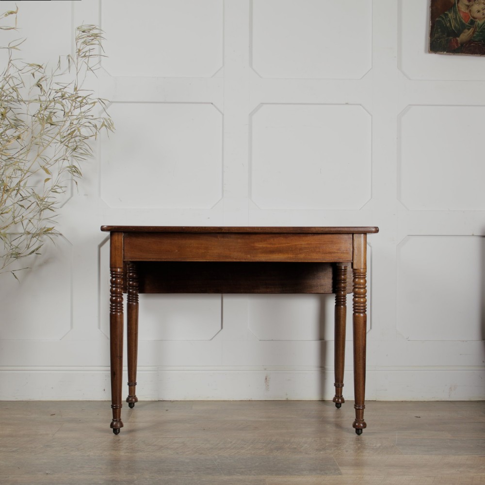 A Victorian mahogany drop-leaf table featuring a single hinged flap, turned legs, and small wheel castors. View IV