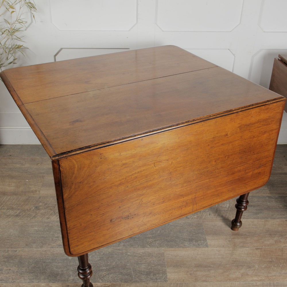 A Victorian mahogany gateleg table with two hinged drop leaves, a rectangular top, and turned wooden legs. View VIII