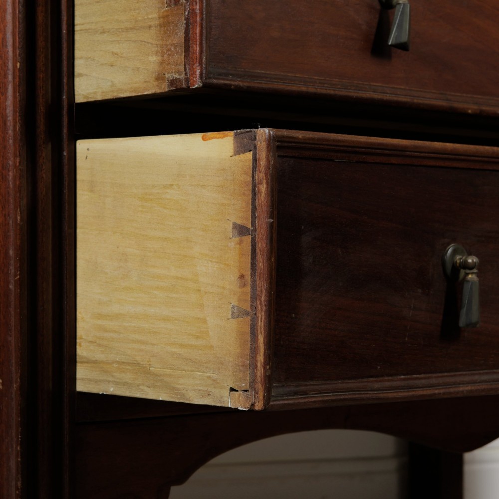 An Edwardian mahogany chest featuring three graduated drawers with drop handles, fluted side pilasters, and a low upstand. View VII