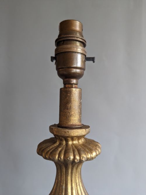fig 1. A white ribbed opaline glass table lamp featuring cast brass floral appliques, an ornate footed base, and a fluted metal neck.
