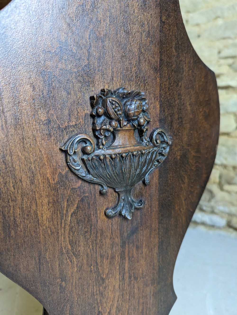 A late 19th-century dark oak trestle table featuring a shaped top with contrasting inlaid border and a low stretcher with a central carved boss. View IX