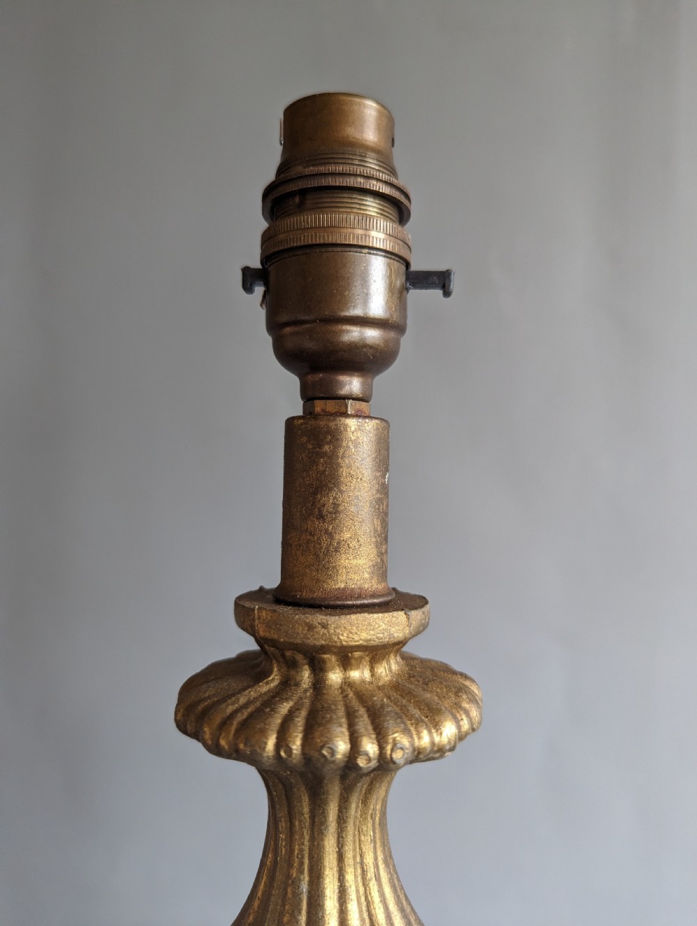A white ribbed opaline glass table lamp featuring cast brass floral appliques, an ornate footed base, and a fluted metal neck. View II