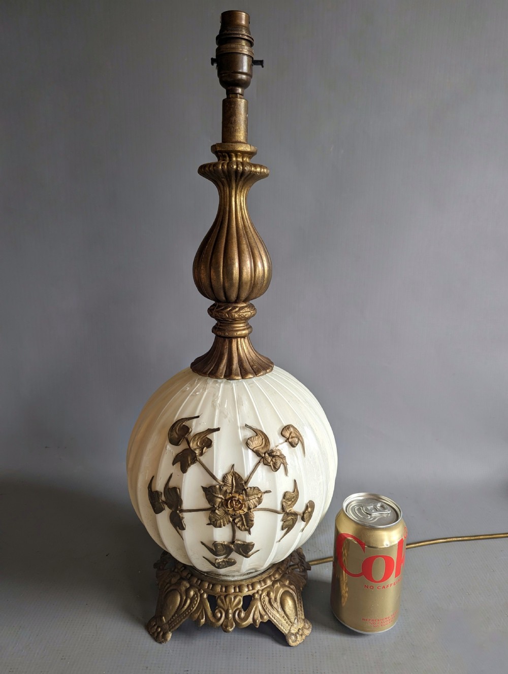 A white ribbed opaline glass table lamp featuring cast brass floral appliques, an ornate footed base, and a fluted metal neck. View VI