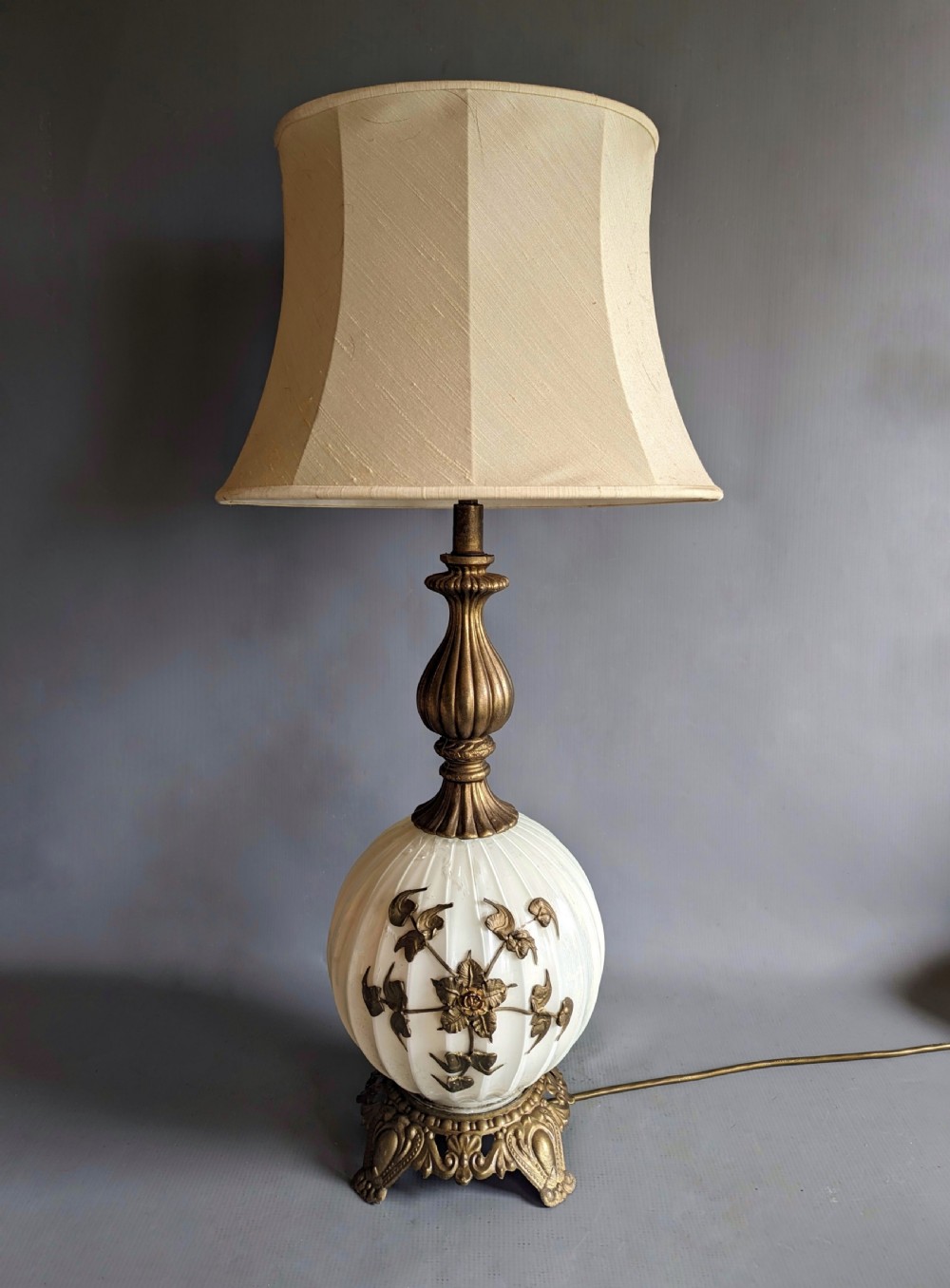 A white ribbed opaline glass table lamp featuring cast brass floral appliques, an ornate footed base, and a fluted metal neck. View VII