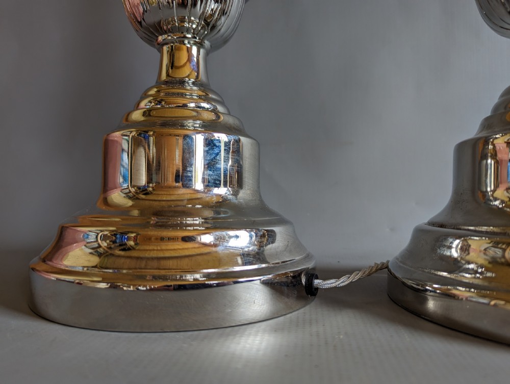A pair of polished silver-toned metal table lamp bases featuring stepped circular bases and turned baluster columns. View IV