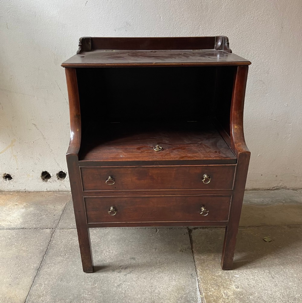A George III mahogany bedside commode featuring an upper open compartment, gallery top, and lower drawers with brass handles. View II