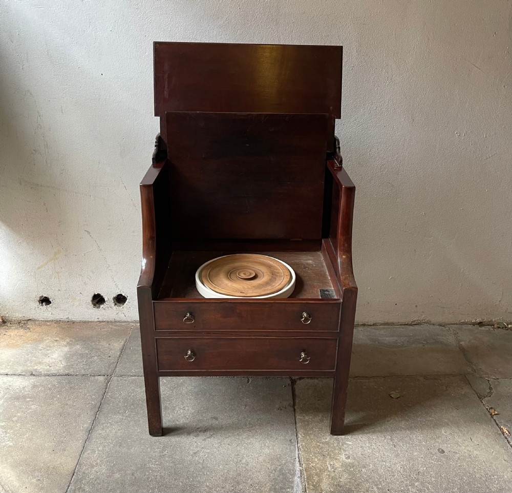 A George III mahogany bedside commode featuring an upper open compartment, gallery top, and lower drawers with brass handles. View IV