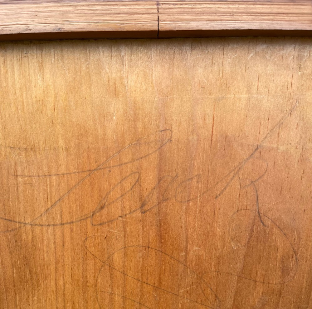 An antique mahogany chest of drawers featuring three short drawers over three long graduated drawers with turned wooden knobs and bun feet. View VI