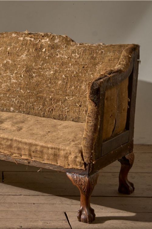 fig 1. A 19th-century mahogany campaign sofa frame with deconstructed hessian upholstery and carved ball and claw feet.