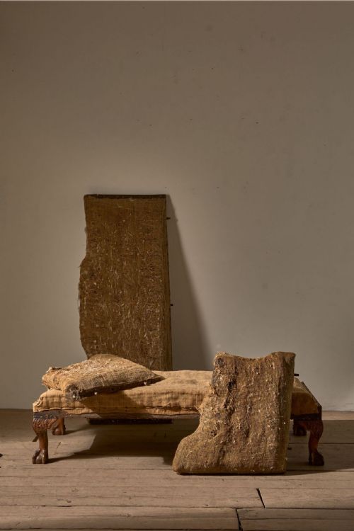 fig 2. A 19th-century mahogany campaign sofa frame with deconstructed hessian upholstery and carved ball and claw feet.