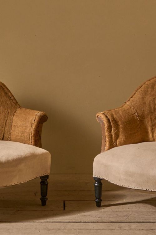 fig 1. A pair of 19th-century French Napoleon III tub chairs with natural hessian upholstery and dark turned wooden legs.