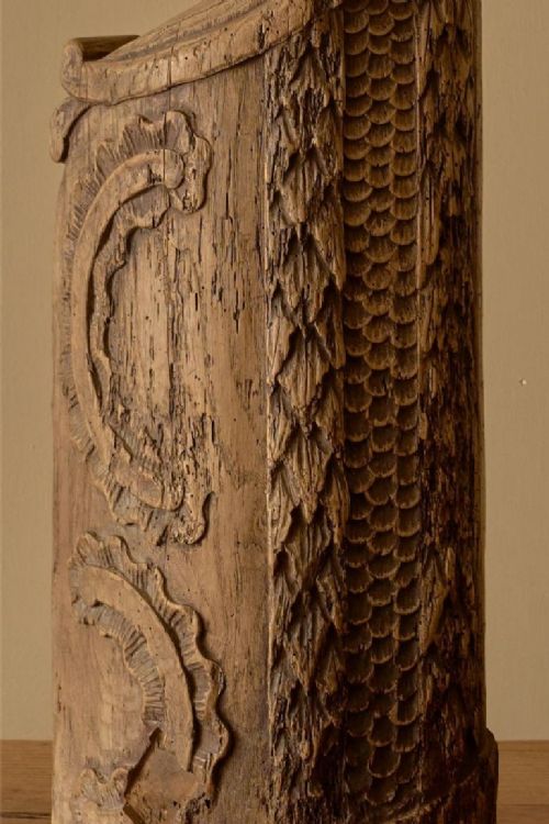 fig 1. A vertical 18th-century hand-carved oak newel post element featuring textured scale carvings, scroll details, and a natural weathered timber finish.