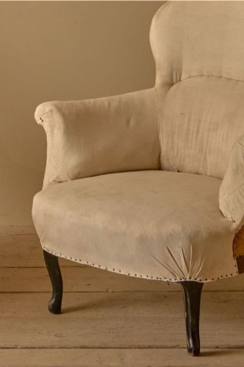 fig 1. A pair of antique Napoleon III armchairs upholstered in cream calico, featuring spoon-shaped backs, scrolled armrests, and dark cabriole front legs.