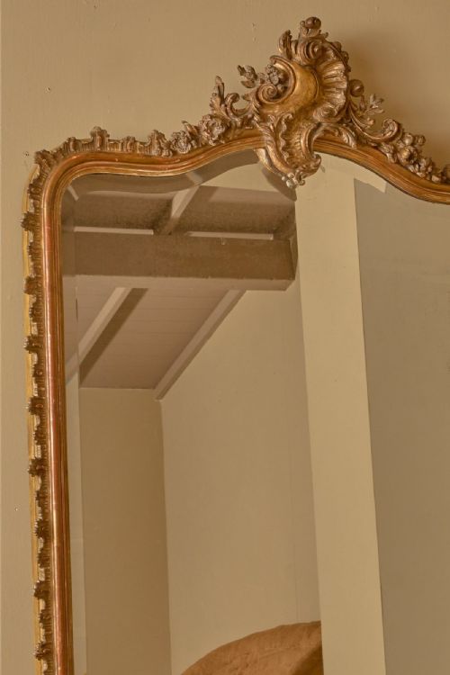 fig 1. A large 19th-century arched overmantel mirror with a gold leaf frame and central carved shell cresting.