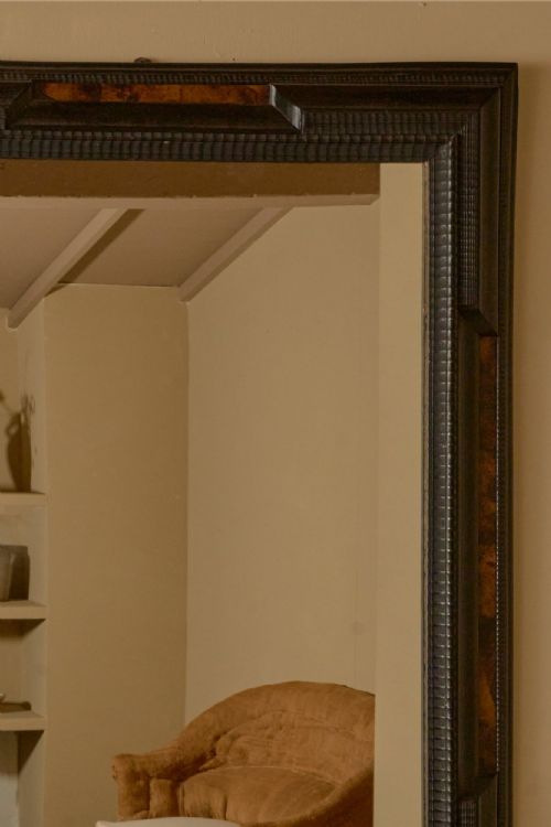 fig 2. A large rectangular 19th-century Italian wall mirror framed in dark ebonised wood with inset faux tortoiseshell panels.
