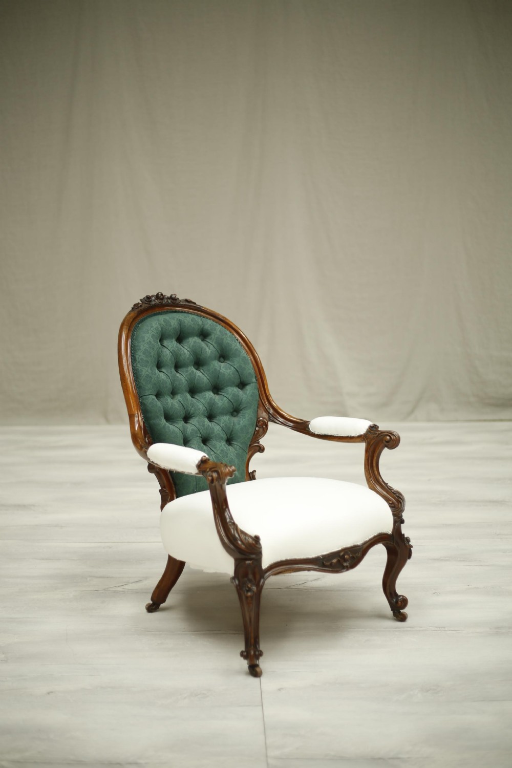Buttoned Early Victorian carved open armchair
