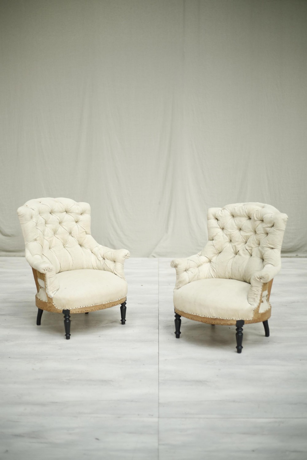 Pair of Napoleon III buttoned shield back armchairs