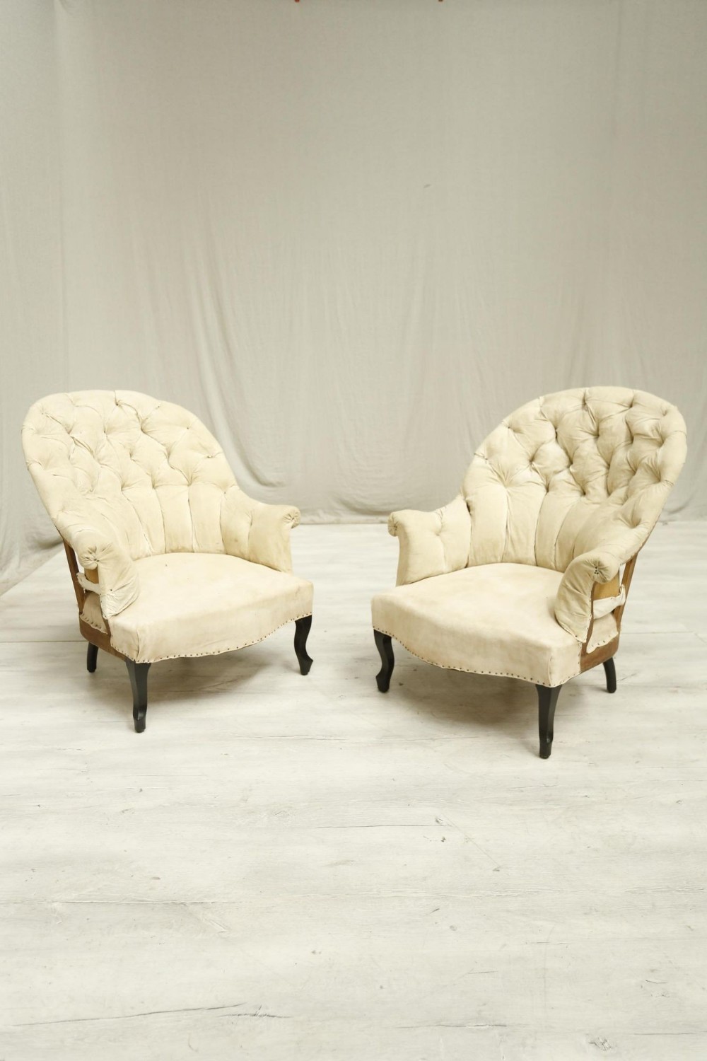 Pair Napoleon III curved buttoned back armchairs